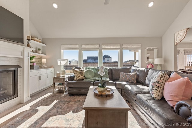 living room with plenty of natural light and high vaulted ceiling