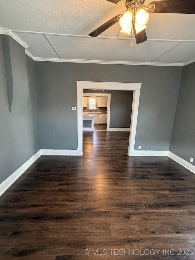 spare room featuring ornamental molding, ceiling fan, and dark hardwood / wood-style flooring