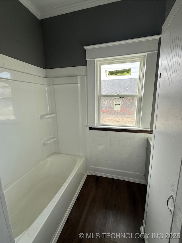 bathroom with hardwood / wood-style floors, ornamental molding, and shower / bath combination