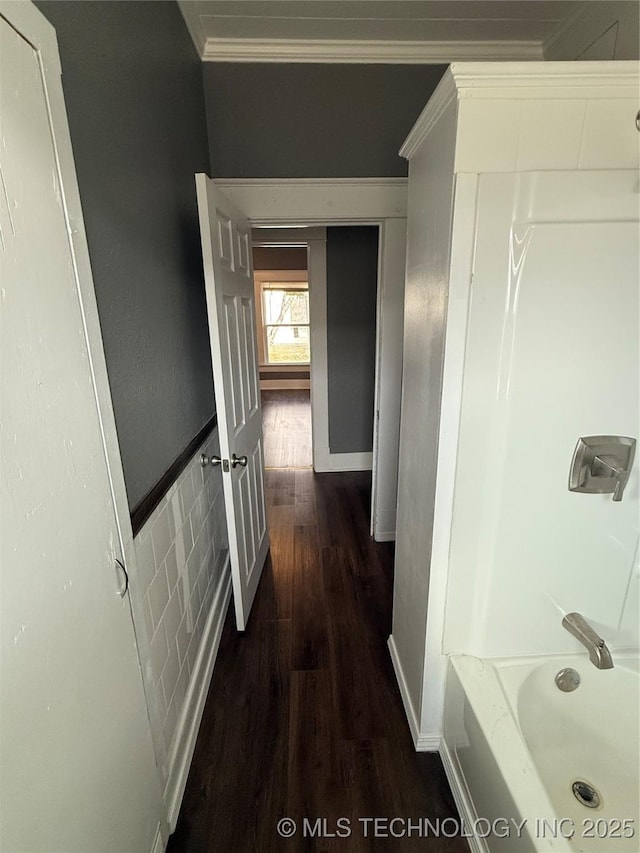 hallway with ornamental molding and dark hardwood / wood-style floors