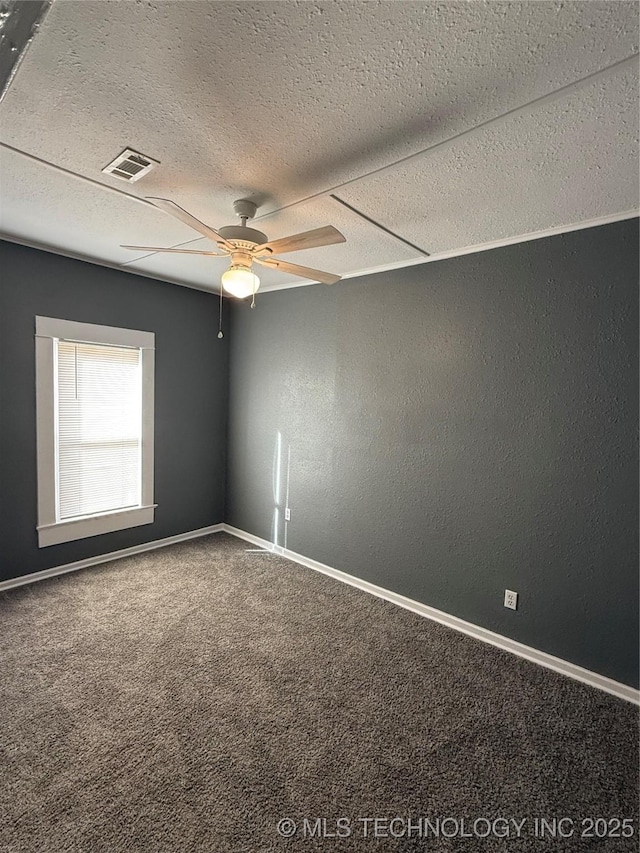 carpeted empty room featuring a textured ceiling and ceiling fan