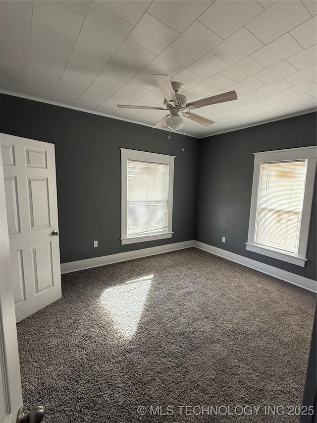 empty room featuring carpet floors and ceiling fan