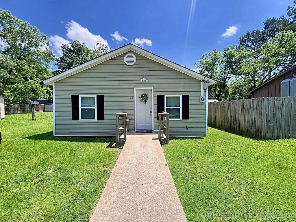 bungalow-style home featuring a front yard