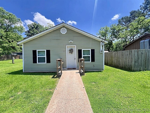 bungalow-style home with a front lawn