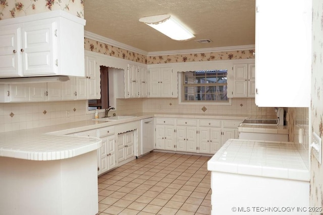 kitchen featuring white cabinetry, tile countertops, and kitchen peninsula