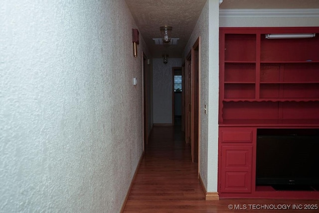 hall featuring hardwood / wood-style flooring and a textured ceiling