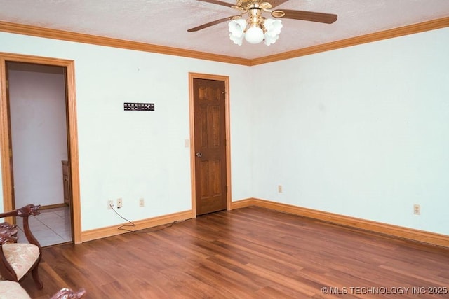 spare room featuring wood-type flooring and ornamental molding