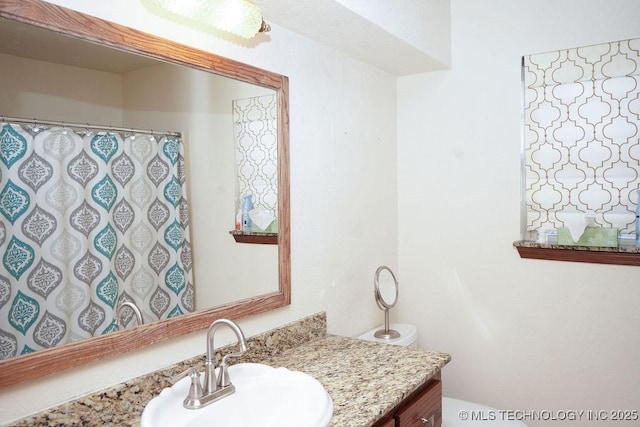 bathroom featuring vanity and toilet