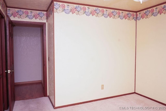 carpeted empty room with a textured ceiling