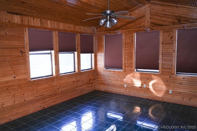 tiled spare room with vaulted ceiling, ceiling fan, wood ceiling, and wooden walls