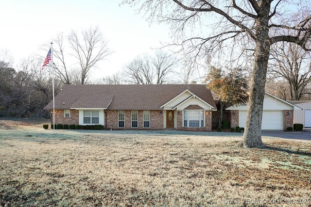 ranch-style house with a garage and a front lawn