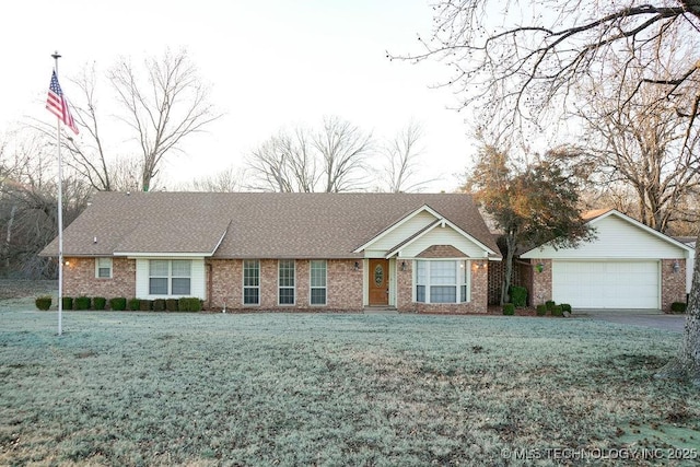 single story home featuring a garage and a front yard