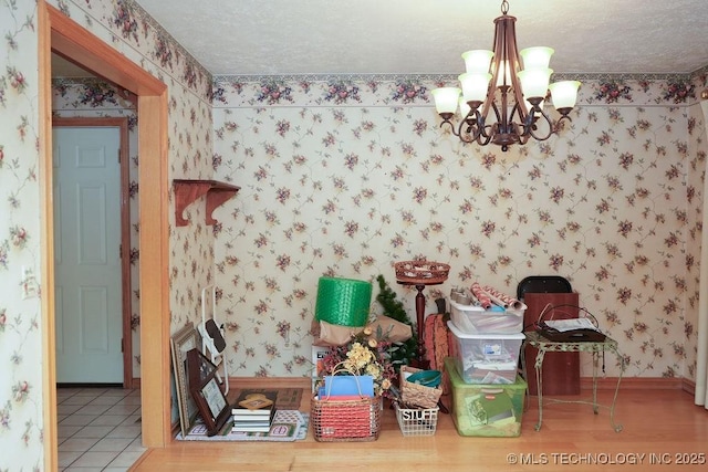 dining area with a notable chandelier and a textured ceiling