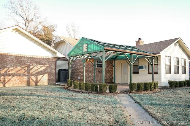 view of front facade with central AC and a front lawn