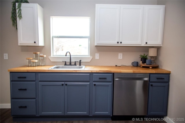 kitchen with dishwasher, sink, white cabinets, and butcher block countertops