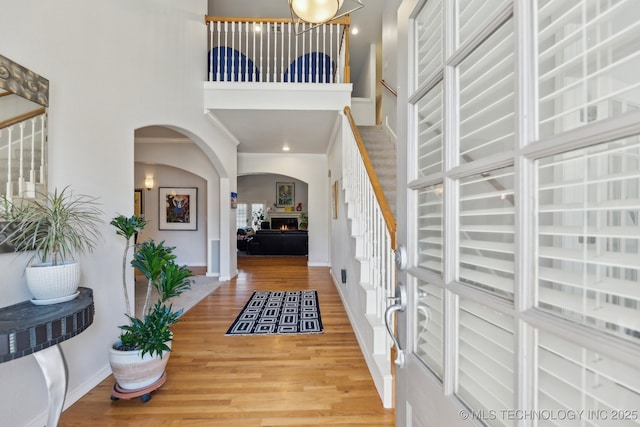 entryway with a towering ceiling and hardwood / wood-style floors