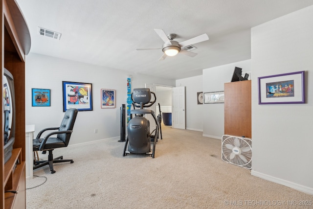 carpeted office space with ceiling fan and a textured ceiling