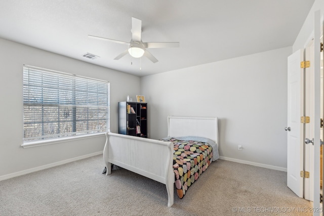 bedroom with ceiling fan and light carpet