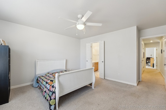 bedroom with light carpet, ceiling fan, and ensuite bath