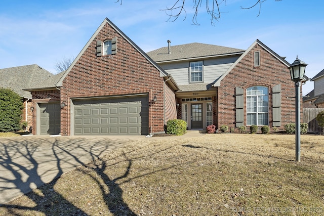 view of front of home with a garage and a front lawn