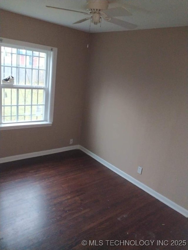 empty room with dark hardwood / wood-style floors and ceiling fan