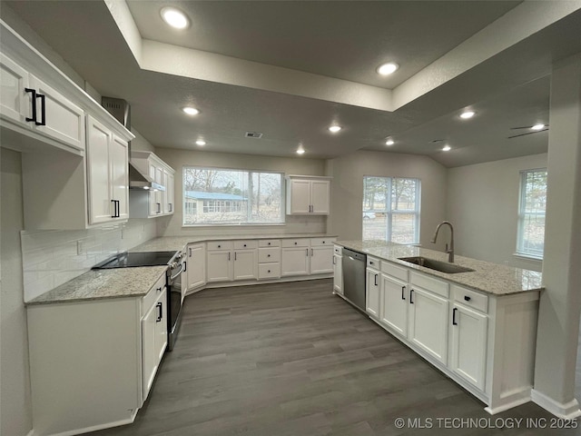 kitchen featuring white cabinetry, stainless steel appliances, sink, and light stone counters