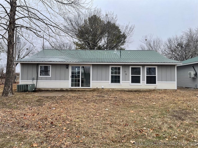 rear view of house featuring central air condition unit