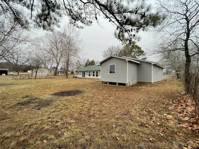 view of side of home featuring a lawn