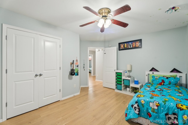 bedroom with ceiling fan, a closet, and light wood-type flooring