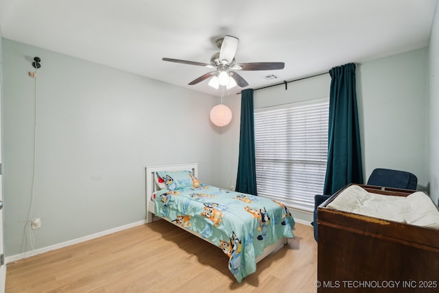 bedroom with ceiling fan and light wood-type flooring