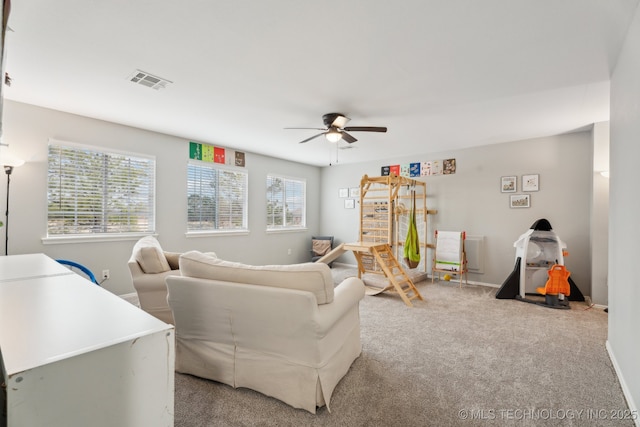 living room featuring light colored carpet and ceiling fan