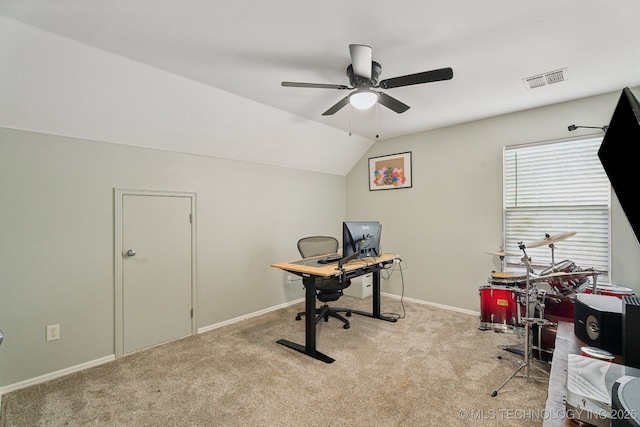 carpeted office space featuring ceiling fan and vaulted ceiling