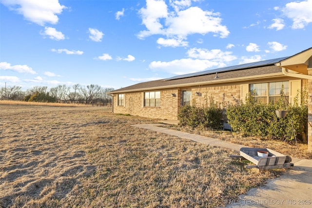 view of side of home featuring solar panels