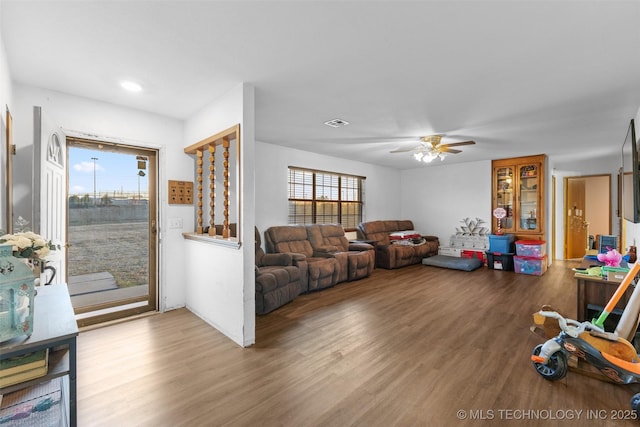 living room with ceiling fan and light hardwood / wood-style flooring