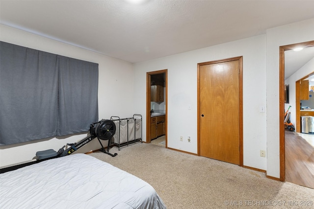 bedroom with connected bathroom and carpet floors