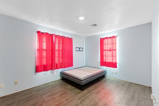 unfurnished bedroom featuring hardwood / wood-style flooring