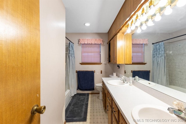 full bathroom featuring vanity, shower / tub combo with curtain, and toilet