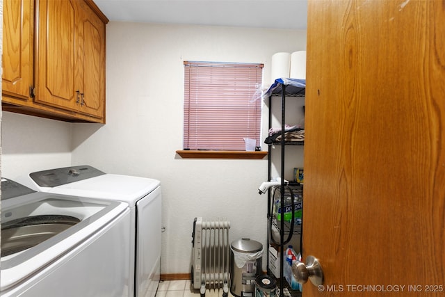 washroom with cabinets, washer and dryer, and radiator heating unit