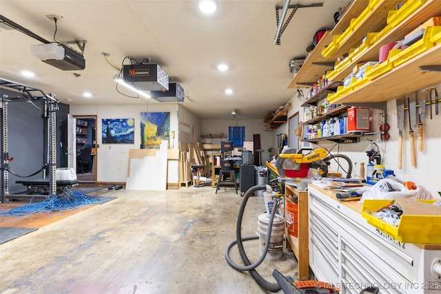 garage featuring a garage door opener and a workshop area