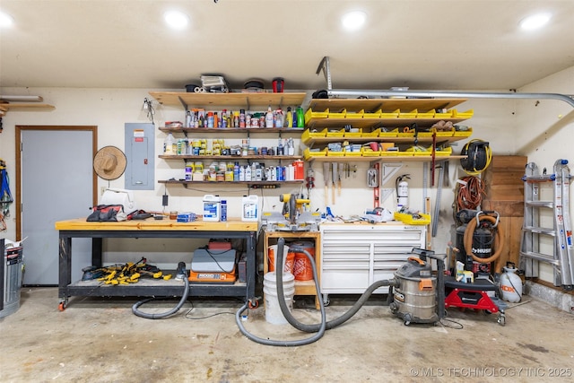 garage featuring electric panel and a workshop area