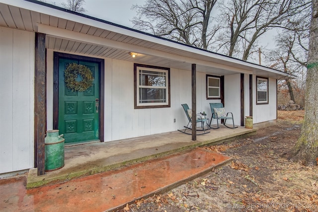 view of exterior entry with covered porch