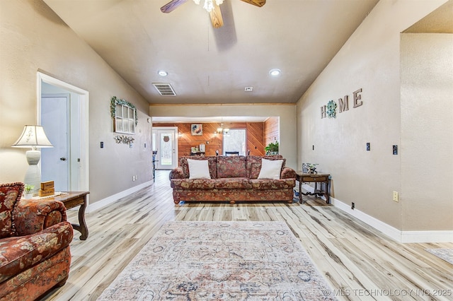 living room featuring light hardwood / wood-style floors and ceiling fan