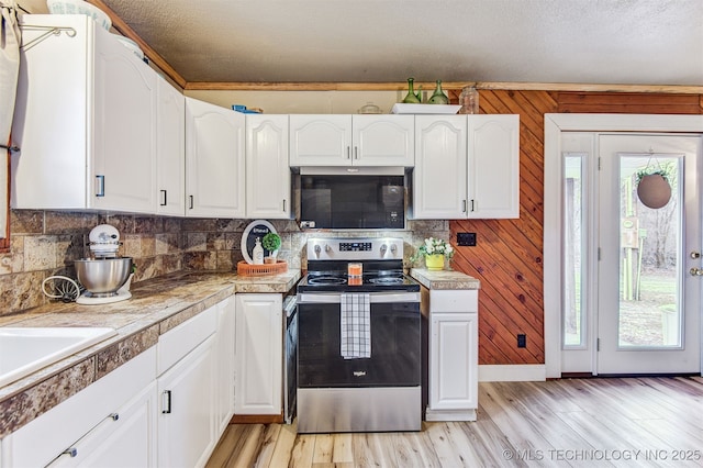 kitchen with a textured ceiling, light hardwood / wood-style floors, stainless steel electric range, and white cabinets