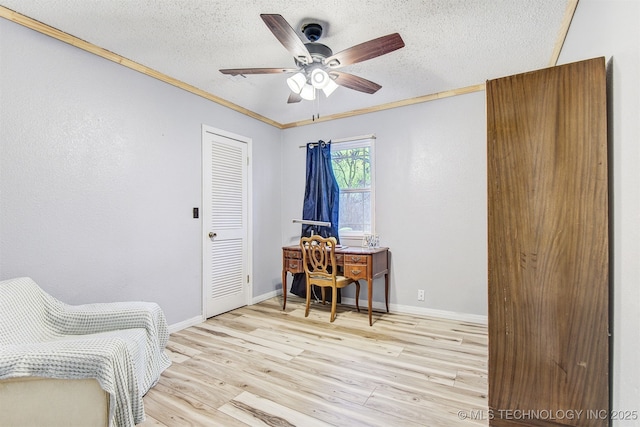 office area with ceiling fan, crown molding, a textured ceiling, and light wood-type flooring