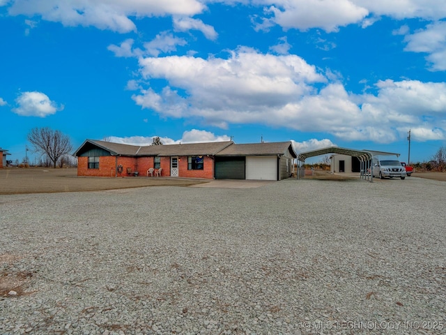 ranch-style house featuring a garage and a carport