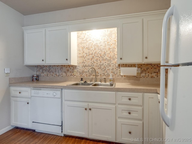 kitchen featuring hardwood / wood-style floors, tasteful backsplash, white cabinetry, sink, and white appliances