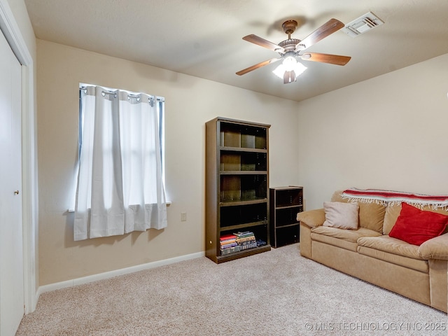 living room with ceiling fan and carpet floors