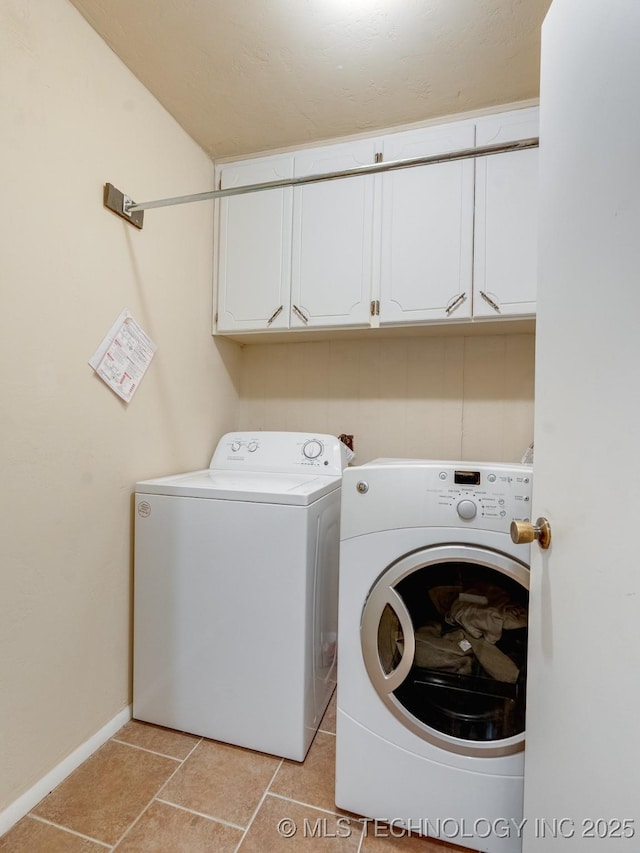 washroom with independent washer and dryer, cabinets, and light tile patterned flooring