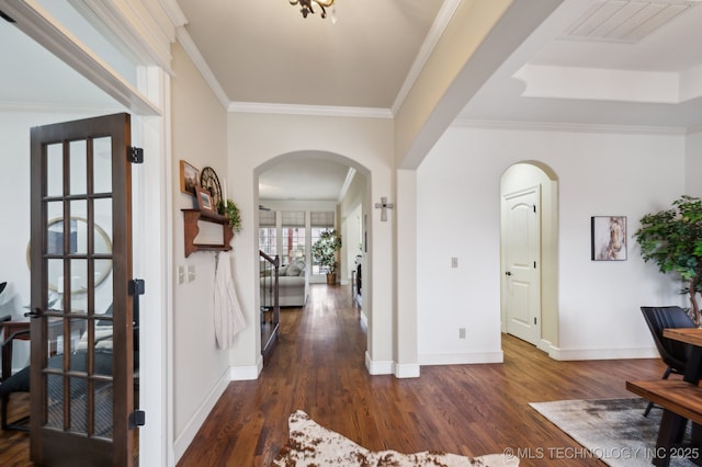 hallway with dark hardwood / wood-style flooring and ornamental molding