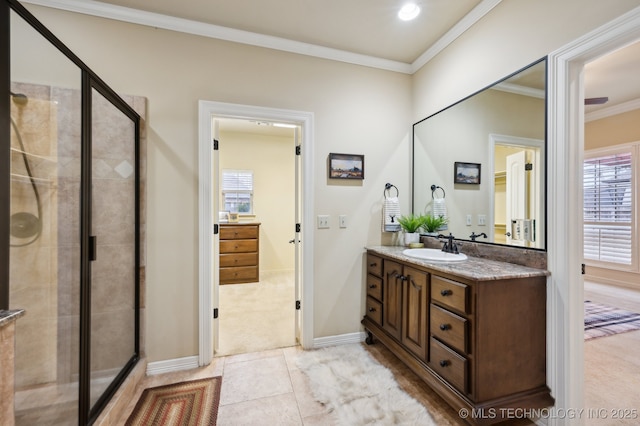 bathroom featuring crown molding, vanity, and an enclosed shower